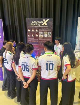MercuriX Racing presenting their design and engineering process to judges, highlighting the depth of analysis, professionalism, and teamwork.
