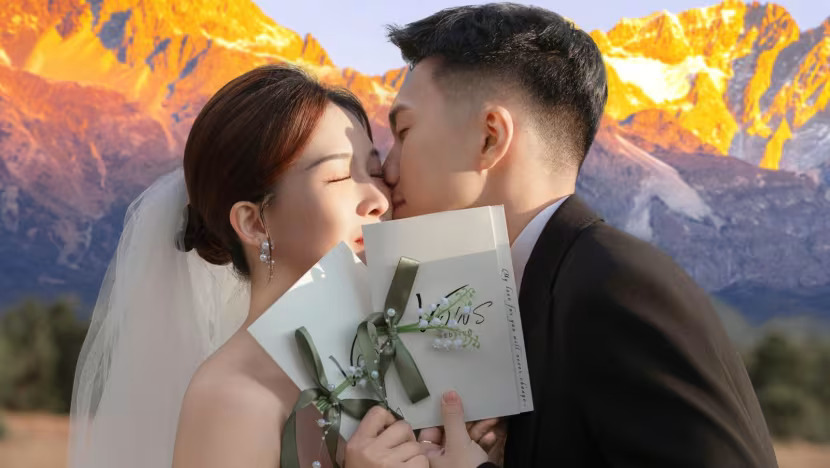 A Malaysian couple's wedding photo in front of Yulong Snow Mountain in Lijiang, Yunnan Province, China.