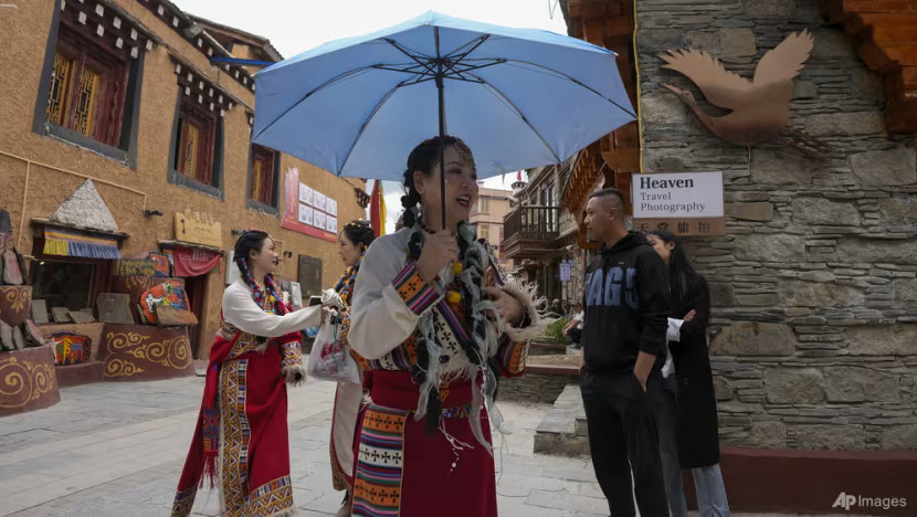 Women wearing Tibetan costumes tour the thousand-household Tibetan village, one of the tourism spot in Litang county, Ganzi Tibetan Autonomous Prefecture of southwestern China's Sichuan province, Friday, Sept. 8, 2023.