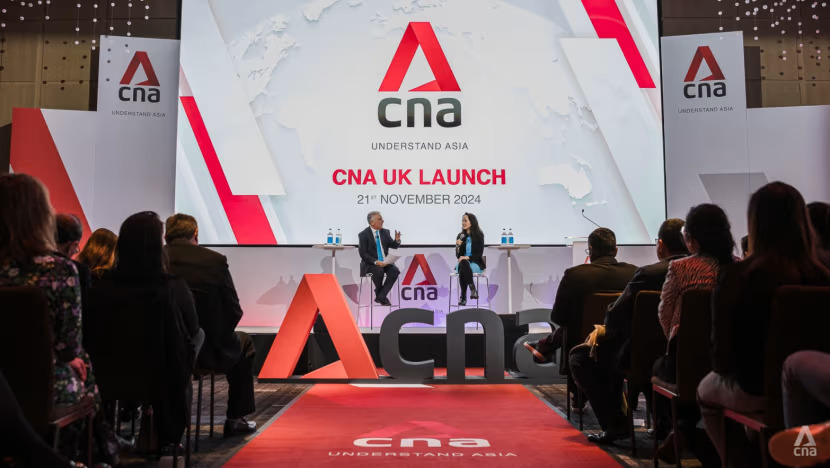 CNA's UK correspondent Simon Marks and journalist Pearl Forss speak on stage during CNA's launch in London.